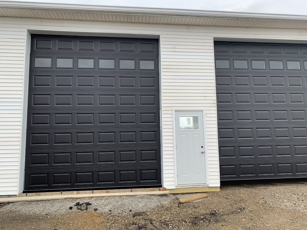 Black traditional garage door with windows