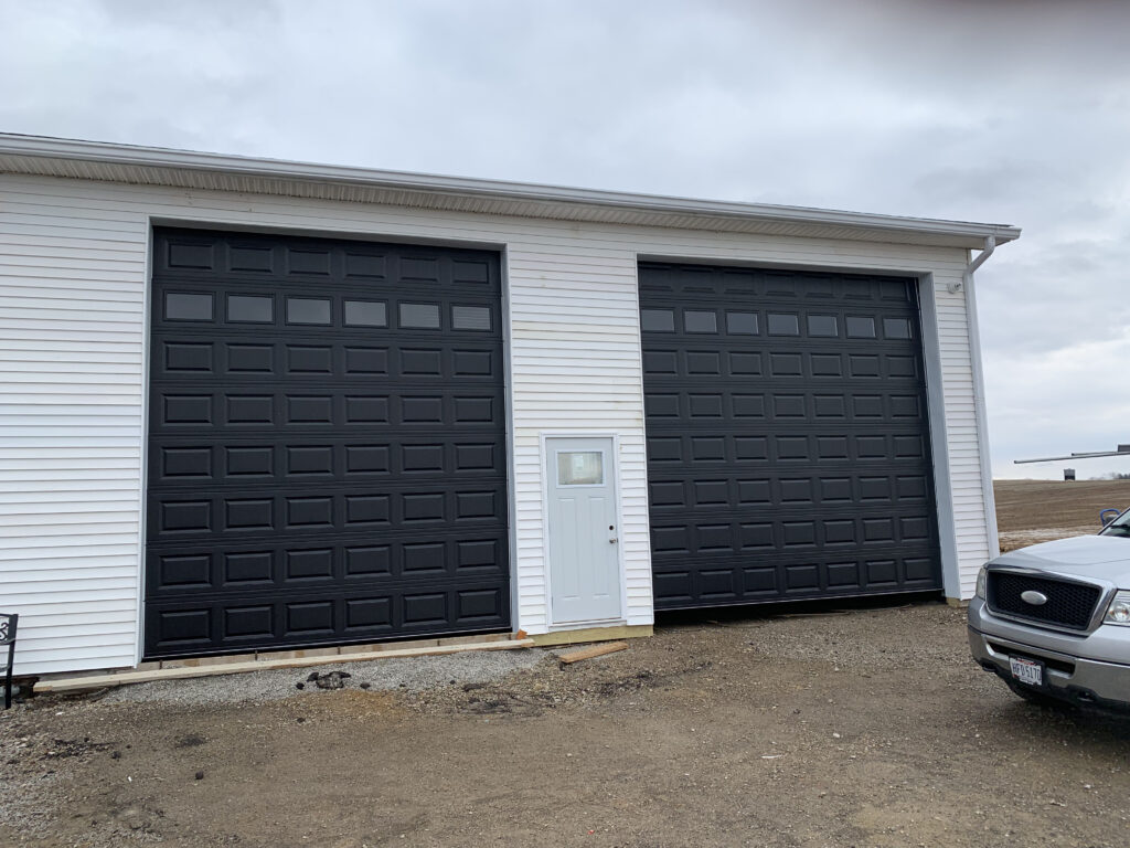 Black traditional garage door with windows