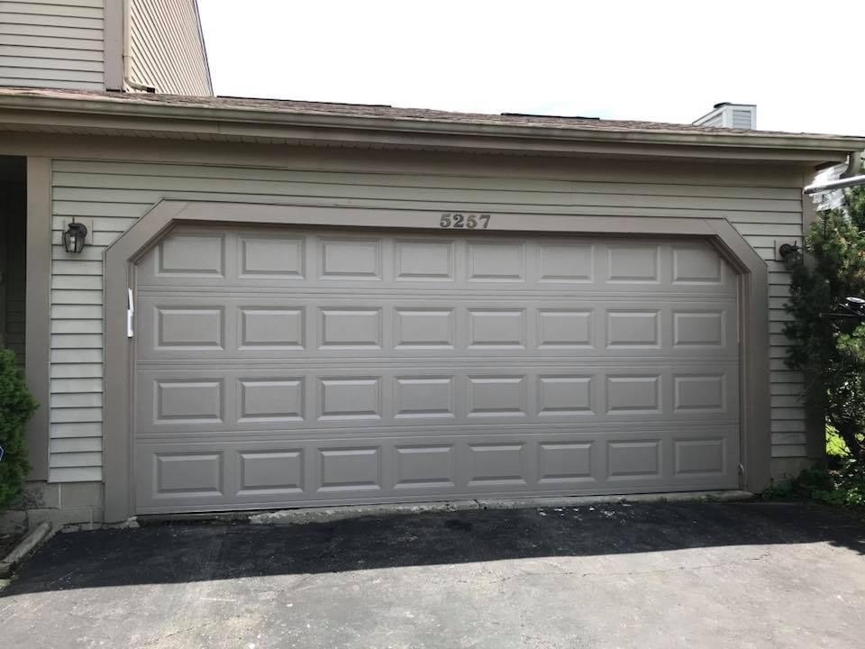 Grey traditional garage door installed by Apex Garage Door Service 