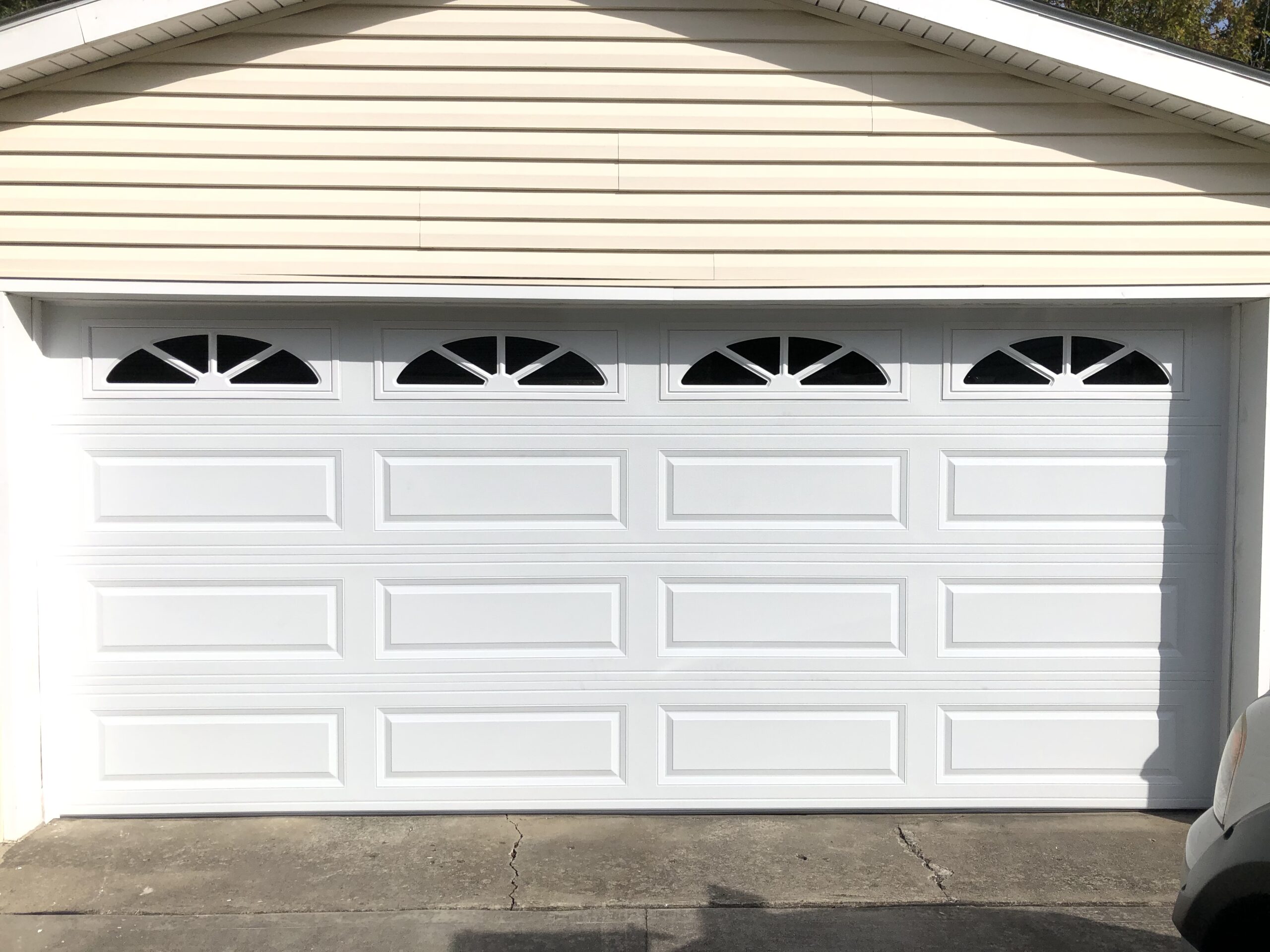 White traditional garage door with decorative windows