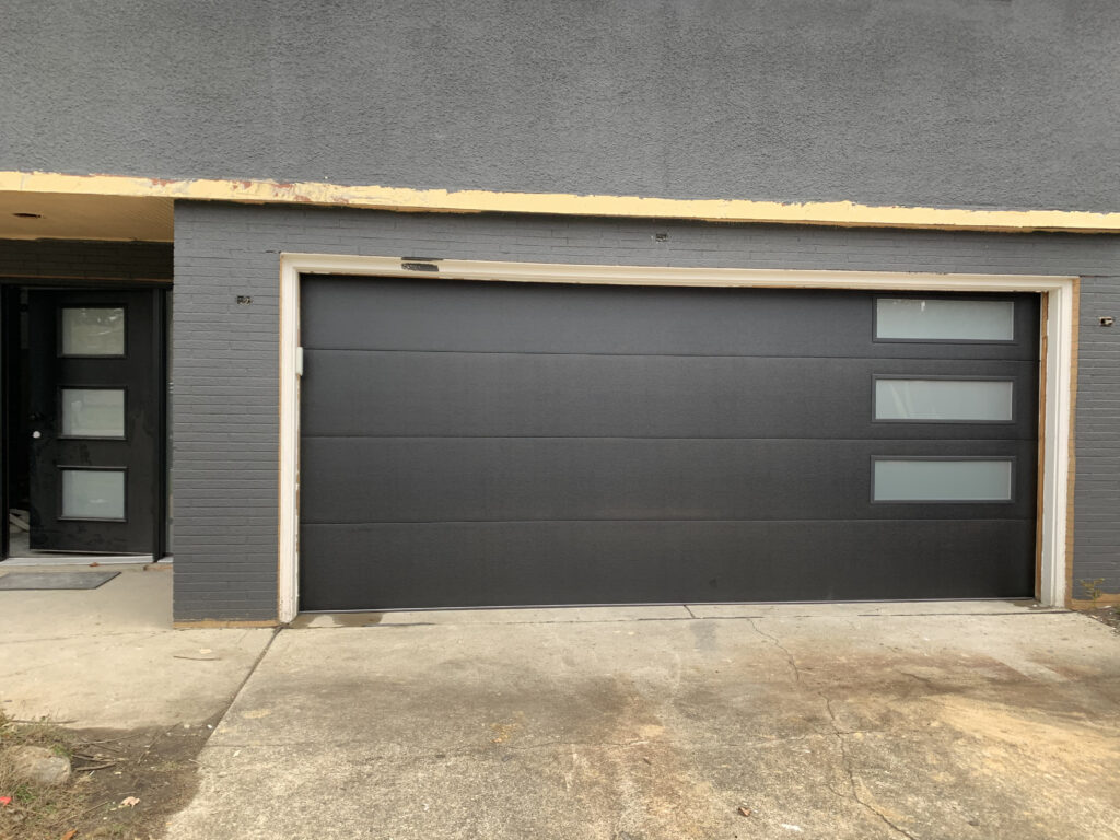 Modern flush panel garage door with 3 windows